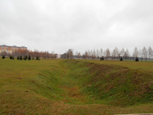 One ditch in a huge field of many partisan-dug  ditches near Mogilev, Belarus. Each ditch is a bit filled in since those originally  hand-dug during the early 1940s. Locals tried to defend their city against the  Nazi invasion.